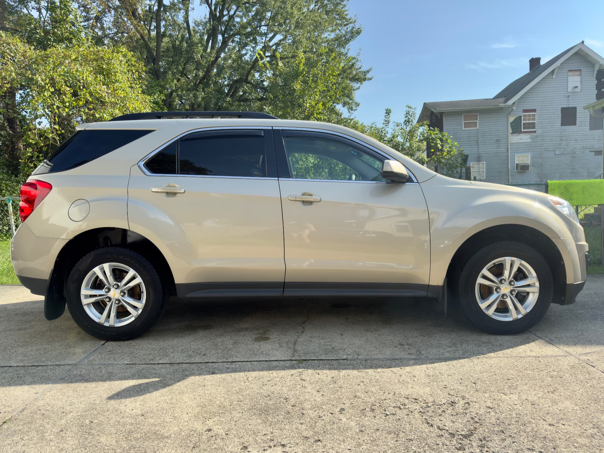 Champagne Chevrolet Equinox SUV freshly detailed and parked on a driveway