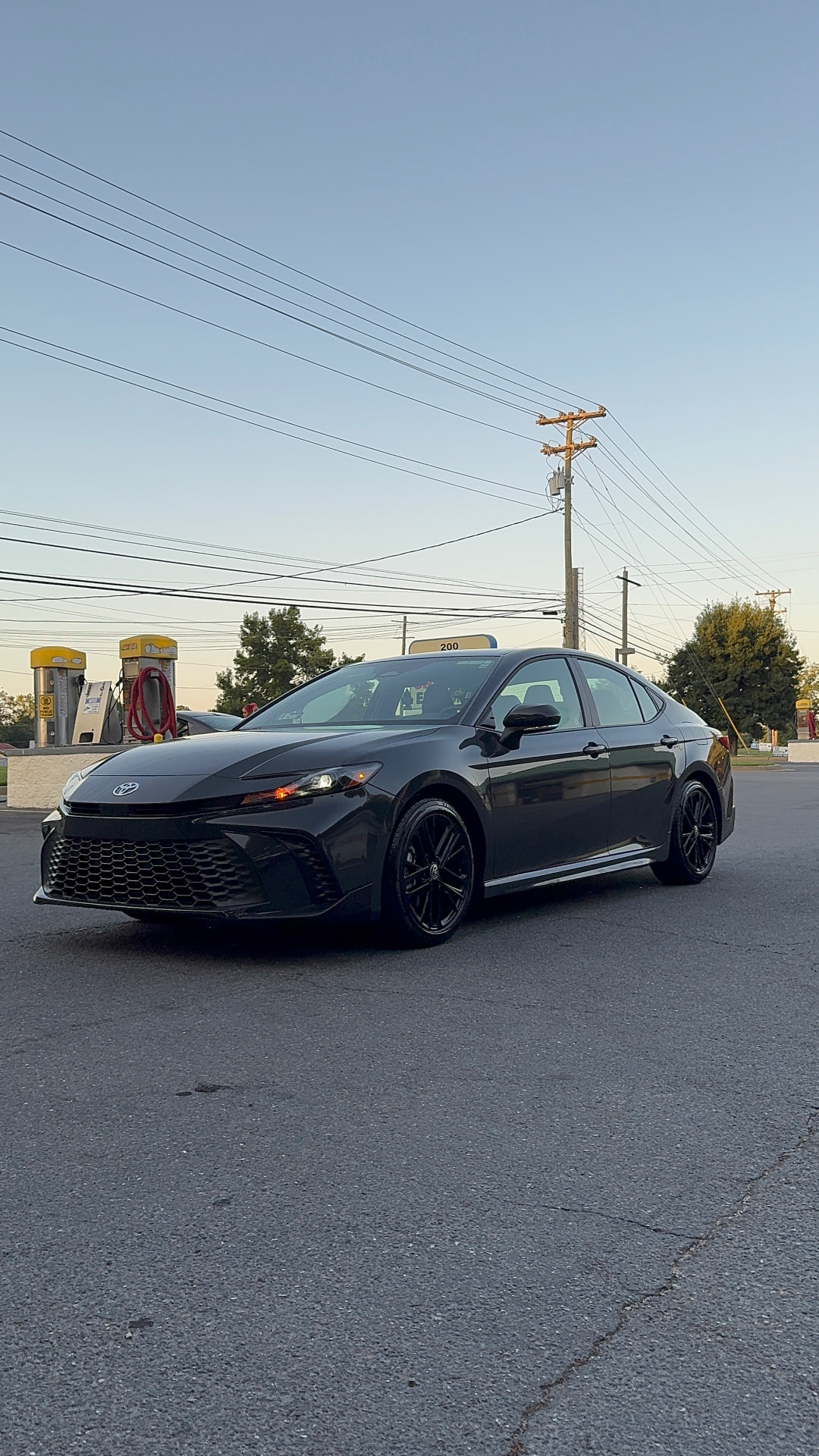 Black Toyota Camry sedan with a fresh wax and polished wheels