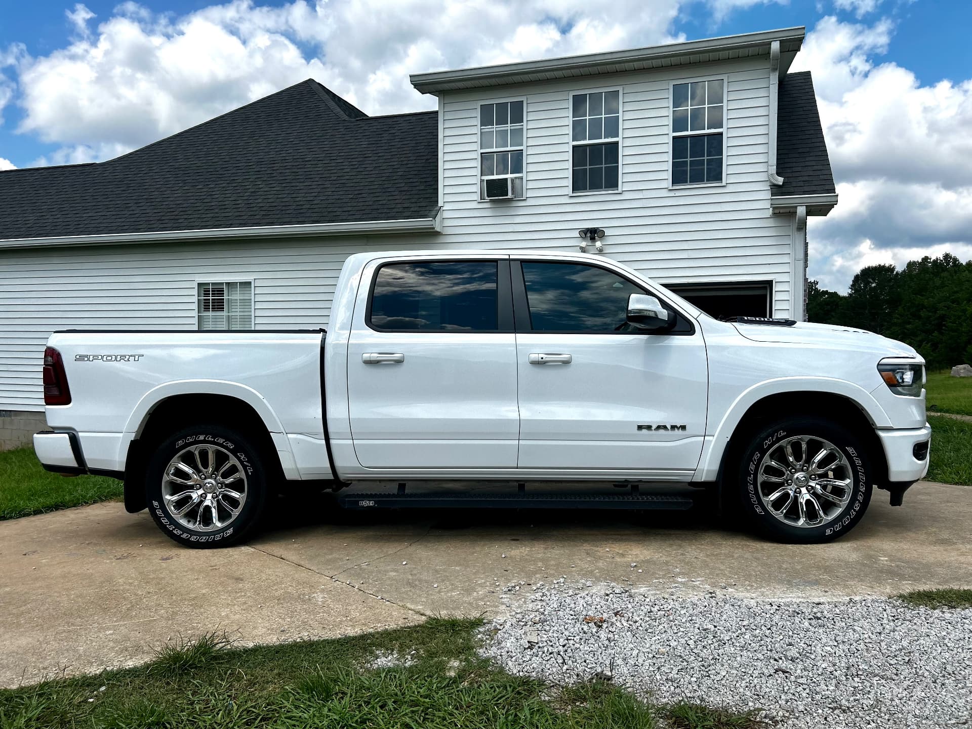 White RAM 1500 Sport pickup truck with a clean paint finish and gloss tires